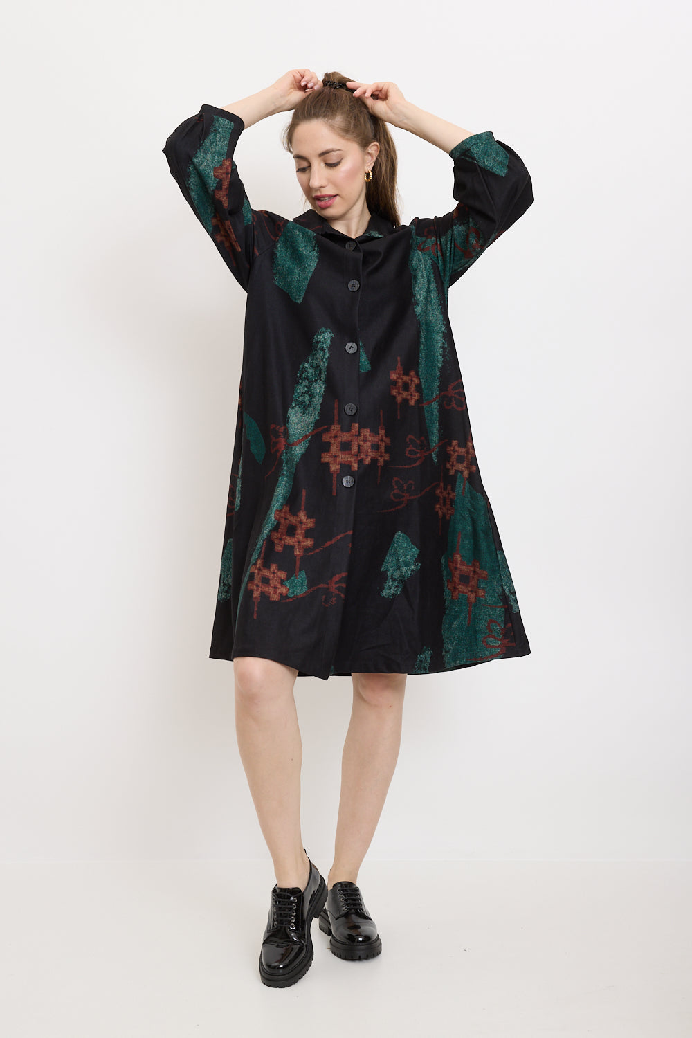 Coat with green shapes and red sharps