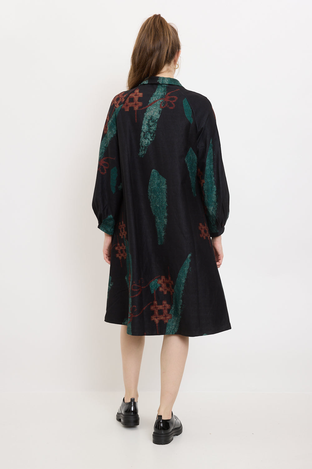 Coat with green shapes and red sharps